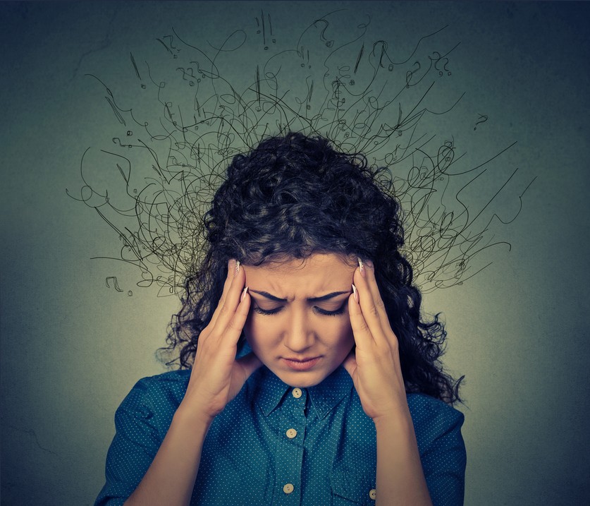 woman under stress with hands on temples